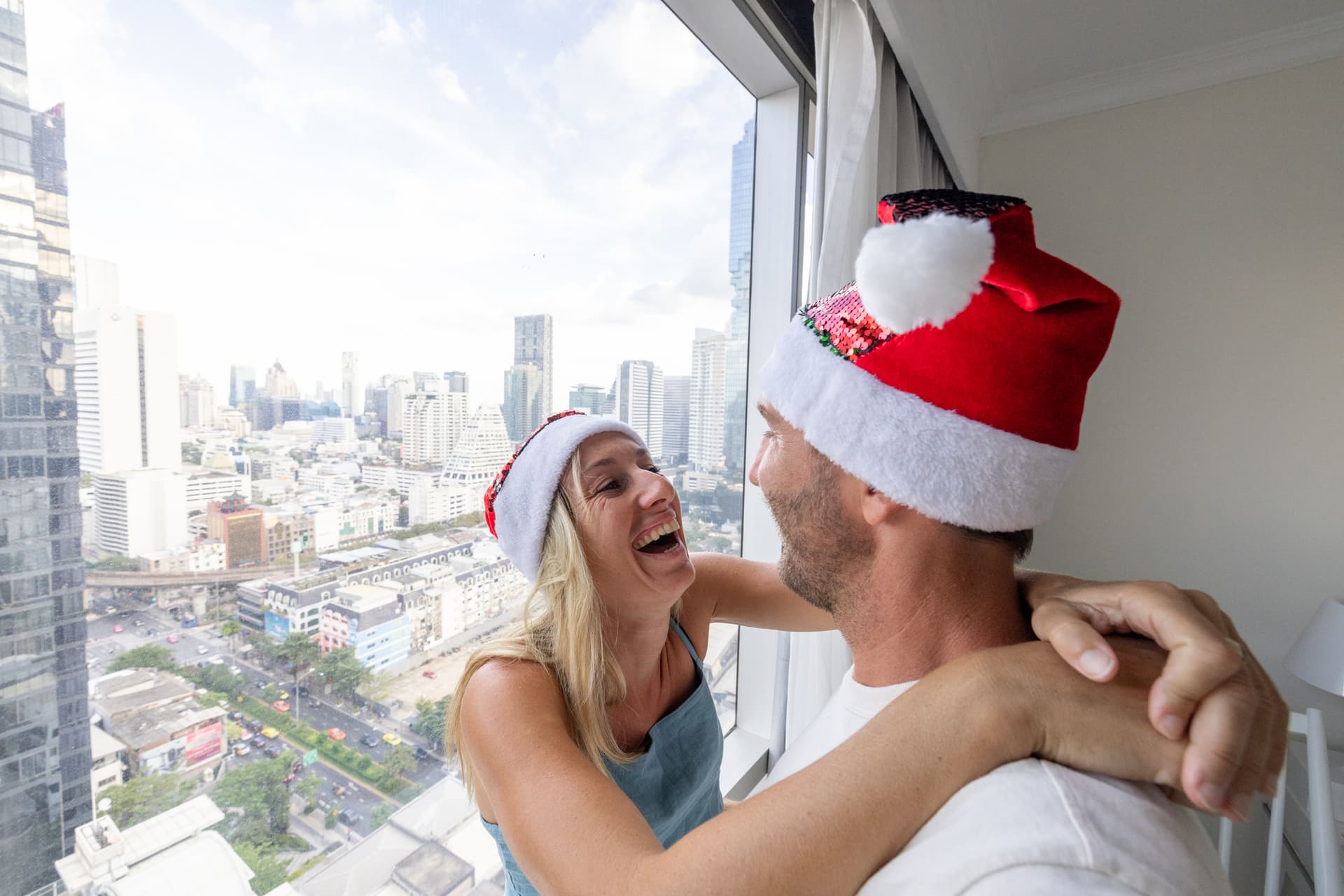 Happy expat couple enjoying their condo with professional window film